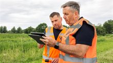 2 mannen in het veld tablet bespreken 2